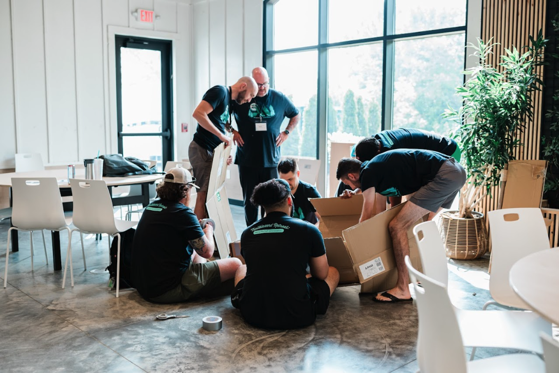 Group of people sitting and standing while collaborating on a team activity during corporate retreat at Retreat 21 near Columbus, Ohio